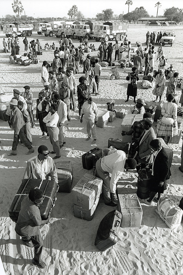 Namibian returnees haul their cases and boxes as they leave Ongwediva reception center in northern Namibia to go back home. 