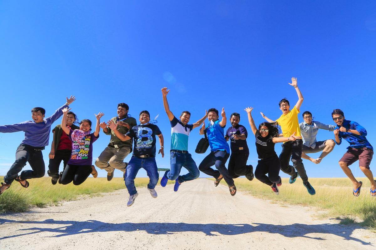 Asian youth expressing their freedom at the gate of Etosha National Park, Namibia. LWF/JC Valeriano 