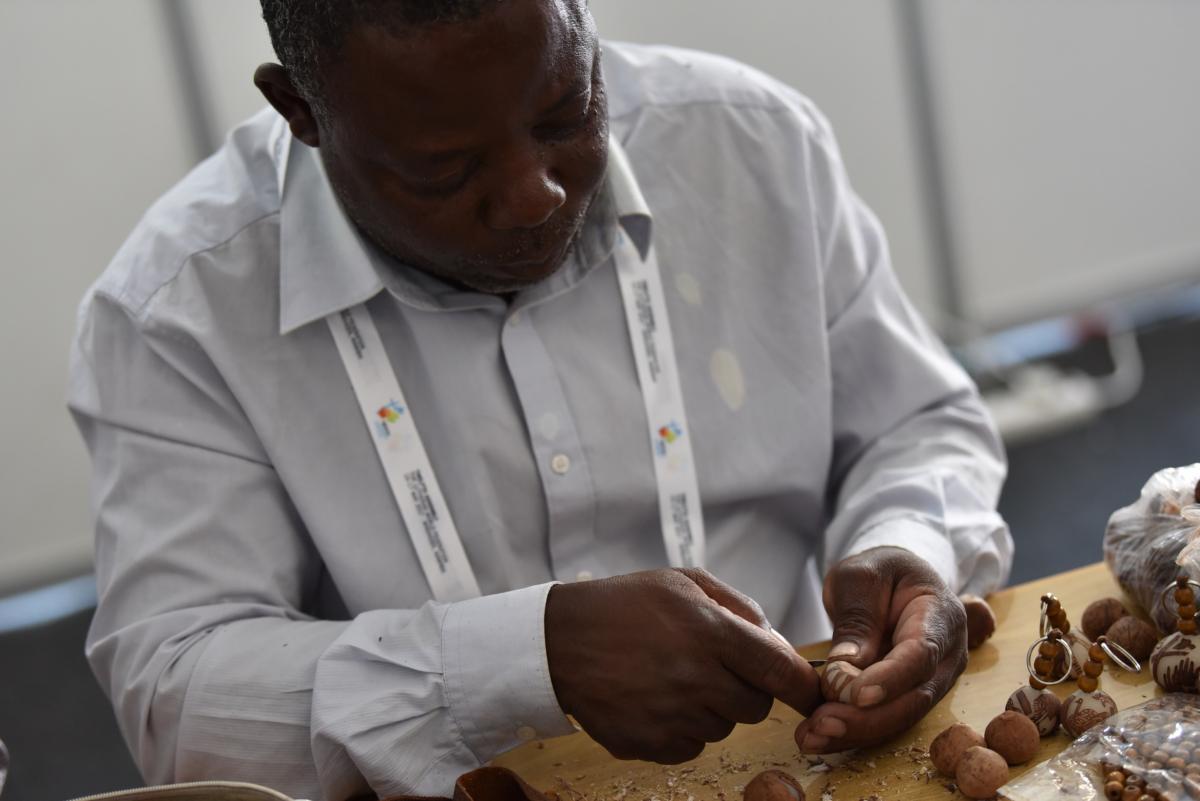 Artist Erwin Eichab carving Makalani nuts. Photo: LWF/Albin Hillert